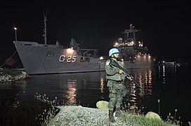 A Marine stands guard as NDCC Almirante Saboia docks in Port-au-Prince during MINUSTAH, 2013.