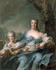 A middle-aged woman a little girl in a park. The woman is wearing a simple blue dress and her daughter, leaning against her legs, is in white. They both hold light pink roses and their hair is in a strict up-do, powdered white.