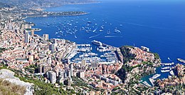 A panoramic view of Monaco. The photo looks down towards the main city and the sea which borders the country.