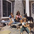 President John F. Kennedy, Jacqueline Kennedy, Caroline Kennedy and John F. Kennedy Jr. with two of Pushinka's puppies and their other family dogs, at Squaw Island, Hyannis Port, 14 August 1963