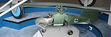 A scale model of a green mini-helicopter