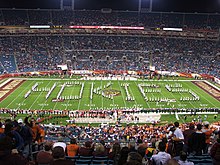 Marching band members stand an spell the word "Hokie" filling the whole of the stadium's playing field in front of thousands of fans in their seats.