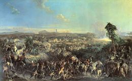 Painting shows a multitude of soldiers in the foreground and a town in the distance.