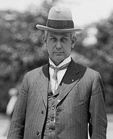 A black-and-white photo of a man in a suit and hat