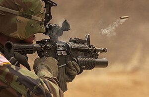 M4 Carbine with with an ejected ammunition casing in mid-air