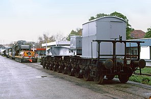 Arrival of a Schnabel wagon at its destination with a large transformer. The load will now be transported by road on a lowboy.