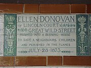 A tablet formed of six standard sized tiles, bordered by green flowers in the style of the Arts and Crafts movement