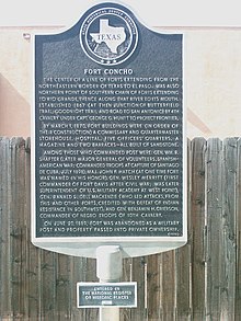 A Texas State Historical Association plaque describing the service history of Fort Concho in metal type: Underneath it is a smaller plaque marking the fort as a National Register of Historic Places property.