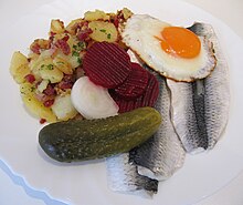 Traditional and simple lunch in Hamburg: Bismarckhering, Bratkartoffeln, and Spiegelei