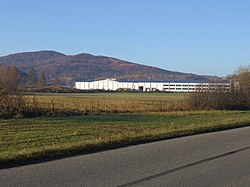 Grodzisko Mountain. In the foreground, the packaging factory in Zegartowice