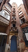 Hôtel de Brucelles (1544): large staircase tower with windows decorated with carved busts.