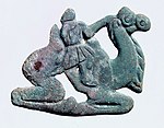 Nomadic figure, typically with a long nose, on a Bactrian camel. Southern Ningxia, 4th century BC.[105][103]