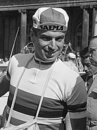 Rik Van Looy wearing a cycling cap with Faema insignia and a white cycling jersey with horizontally rainbow stripes across the chest