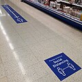 Social distancing floor signs in an Irish supermarket in August 2020.