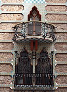 Windows with wrought iron grille and upper balcony