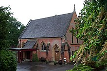 chapel-style red brick building with steep pitched slate roof