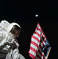 Schmitt poses by the American flag, with Earth in the background, during Apollo 17's first EVA.