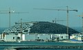 Louvre Abu Dhabi under construction in 2015, its dome built up of layers of stars made of octagons, triangles, and squares