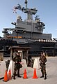 The Naval Support Activity Souda Bay's Security Department soldiers stand a security watch in front of the French aircraft carrier FS Charles DeGaulle (R 91) as it docks at the Marathi NATO pier facility in Souda Bay.