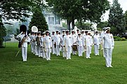 Captain George N. Thompson, commanding officer of the United States Navy Ceremonial Band, leads the Drum Major and band members as they render honors during a 19-gun salute at the swearing-in ceremony for Secretary of the Navy (SECNAV) the Honorable Ray Mabus at the Washington Navy Yard.