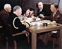 Four uniformed men seated at lunch table