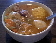 Caldo de res is a Mexican dish made with corn, green beans, potatoes, carrots, cabbage and cilantro.