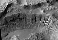 Crater wall inside Mariner Crater showing a large group of gullies, as seen by HiRISE