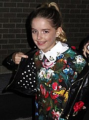 McKenna Grace posing against a black background at the I, Tonya premiere in 2017