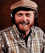 A close-up of Mike Love smiling
