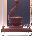 Modern reproduction of a Yazh, an instrument used in Ancient Tamil music. This reproduction has a yali head carved into the curved neck.