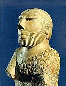 The Priest-King; c. 2400–1900 BC; steatite; height: 17.5 cm; National Museum of Pakistan (Karachi)[188]