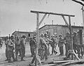 American soldiers view a gallows.