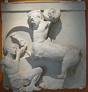 Sculpture of a man fighting a centaur.