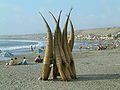 Contemporary reed boats stacked on a beach in Peru