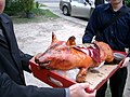 Roast suckling pig bearing 囍 (Double Happiness) placard at a Cantonese wedding