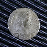 A smaller silver coin in the centre a head – still a fairly round coin but the inscription is not intact and there is no space between it and the rim