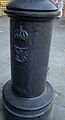 Base of a Spanish style lamp post with the cypher of King Ferdinand VII