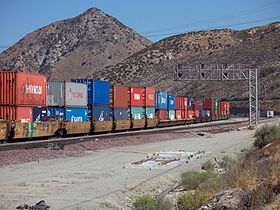 A BNSF double-stack train passing through Cajon Pass in California, with a mix of 20-foot and 40-foot containers