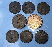 a group of worn copper tokens