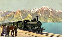 Train hauled by a B 3/4 on the shores of Lake Geneva with the Savoy Alps in the background.