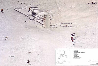 An aerial view of the Amundsen–Scott South Pole Station taken in about 1983. The central dome is shown along with the arches, with various storage buildings, and other auxiliary buildings such as garages and hangars.