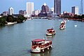 Packet boats on the Genesee River, with the Rochester skyline in the background, USA