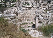 A ruined wall and stairs made of stone.