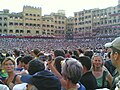 The crowd fills the Piazza del Campo just before departure.