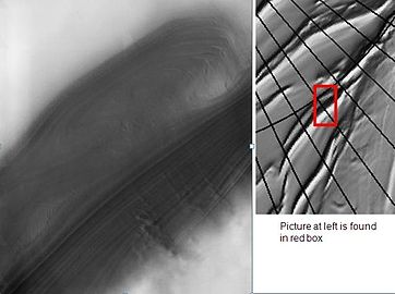 Layers exposed in a valley on the north polar ice cap as observed by Mars Odyssey. Click on image to enlarge to see clouds of dust caused by winds coming off the cap.