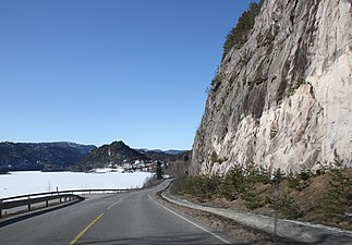 Norwegian National Road 41 passing between steep cliffs and the lake Kviteseidvatnet