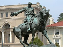 statue of soldier on horse waving his hat
