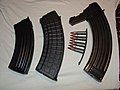 Three magazines and a stripper clip loaded with 7.62×39mm ammunition