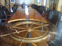 Britannia Yacht Club's Commodore Boardroom features a ship's wheel table