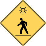 Crosswalk with flashing lights ahead.